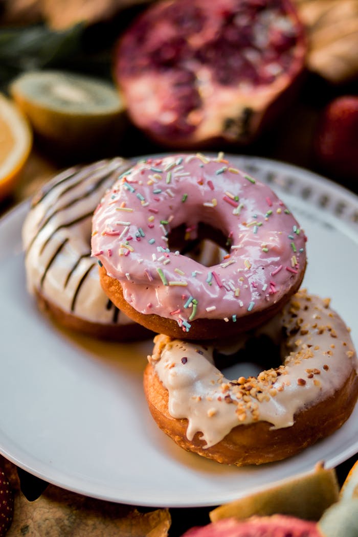 services-02 A mouthwatering trio of donuts with various toppings, perfect for sweet cravings.